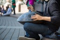 Male drummer playing music instrument hang street