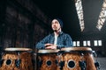 Male drummer plays on wooden drum