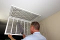 Male Dusting the Inside of a Home Furnace Intake Air Vent Grid