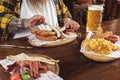 Male eating sausages with arms in boozer