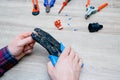 A male electrician changes the plug on an electric wire. Working with electrical tools. Stripper, crimp, screwdriver, wire cutters Royalty Free Stock Photo