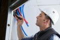 Male electrician checks serviceability Royalty Free Stock Photo