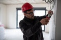 Male electrician cutting electrical wires with pliers Royalty Free Stock Photo