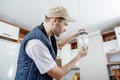 A male electrician fixing light on the ceiling. Royalty Free Stock Photo