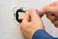 Male electrician repairing electric switch