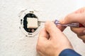 Male electrician repairing electric switch