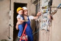 Man showing electrical panel to little boy in apartment. Royalty Free Stock Photo