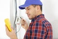 male electrician using multimeter to test wiring Royalty Free Stock Photo
