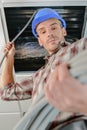 Male electrician working on ceiling