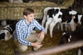 Male employee with dairy cattle in livestock farm Royalty Free Stock Photo