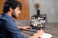 Male employee involved video meeting on the laptop with diverse workteam Royalty Free Stock Photo