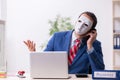 Male employee with mask in hipocrisy concept Royalty Free Stock Photo