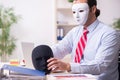 Male employee with mask in hipocrisy concept Royalty Free Stock Photo