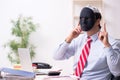 Male employee with mask in hipocrisy concept Royalty Free Stock Photo