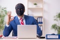 Male employee with mask in hipocrisy concept Royalty Free Stock Photo