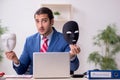 Male employee with mask in hipocrisy concept Royalty Free Stock Photo