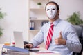 Male employee with mask in hipocrisy concept Royalty Free Stock Photo