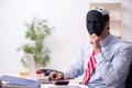 Male employee with mask in hipocrisy concept Royalty Free Stock Photo