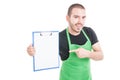Male employee pointing and holding clipboard Royalty Free Stock Photo