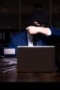 Male employee stealing information in the office night time Royalty Free Stock Photo