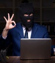 Male employee stealing information in the office night time Royalty Free Stock Photo