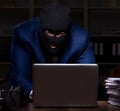 Male employee stealing information in the office night time Royalty Free Stock Photo