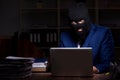 Male employee stealing information in the office night time Royalty Free Stock Photo