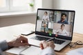 Male employee talk on team video call with colleagues coworkers. Business man has webcam digital virtual conference at home office Royalty Free Stock Photo