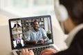 Male employee talk on video call with diverse colleagues