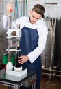 Male employee using machine to cork wine at sparkling wine factory Royalty Free Stock Photo