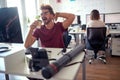 A male employee is yawning while working at the desk in the office. Employees, job, office Royalty Free Stock Photo