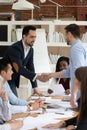 Male employees handshake get acquainted at business meeting