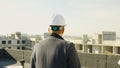 Male engineer-architect overseeing construction progress from the roof Royalty Free Stock Photo