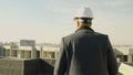 Male engineer-architect overseeing construction progress from the roof Royalty Free Stock Photo