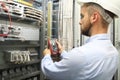 Male engineer are checking electrical system with electronic tools. Royalty Free Stock Photo
