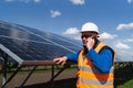 Male engineer in hardhat standing near solar panels and talking on the phone. Royalty Free Stock Photo