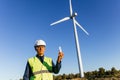 Male engineer holding a light bulb while working in a wind farm. Royalty Free Stock Photo