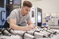 Male Engineer Measuring CAD Drawings In Factory