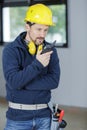 Male engineer with walkie talkie indoors