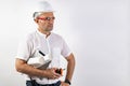 Male engineer in a white hard helmet. A middle-aged man in a white shirt, goggles, with blueprints and a tablet computer. Royalty Free Stock Photo