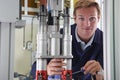 Male Engineer Working On Machine In Factory Royalty Free Stock Photo