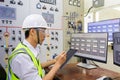 Male engineerr working in electrical control room in the heavy factory. Professional industrial engineer operating in electricity Royalty Free Stock Photo