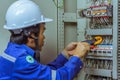 Male engineers are checking the electrical system with electronic tools, clamp-on, clip amp ,clamp meter Royalty Free Stock Photo