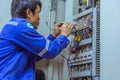 Male engineers are checking the electrical system with electronic tools, clamp-on, clip amp ,clamp meter Royalty Free Stock Photo