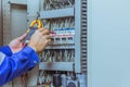 Male engineers are checking the electrical system with electronic tools, clamp-on, clip amp ,clamp meter Royalty Free Stock Photo