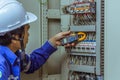 Male engineers are checking the electrical system with electronic tools, clamp-on, clip amp ,clamp meter Royalty Free Stock Photo