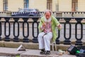 Male entertainer in period outfit awaiting tourists for photo opportunities near Palace Square in Saint Petersburg, Russia