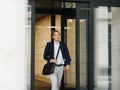 Male entrepreneur exiting from office building