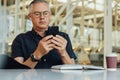 Male entrepreneur using mobile phone at desk in office Royalty Free Stock Photo