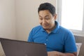 Male Entrepreneur Working Online Business From Home, Happy Smiling Expression Looking at Laptop Royalty Free Stock Photo